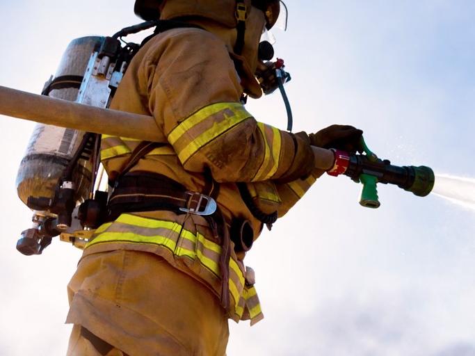 firefighter using a water hose